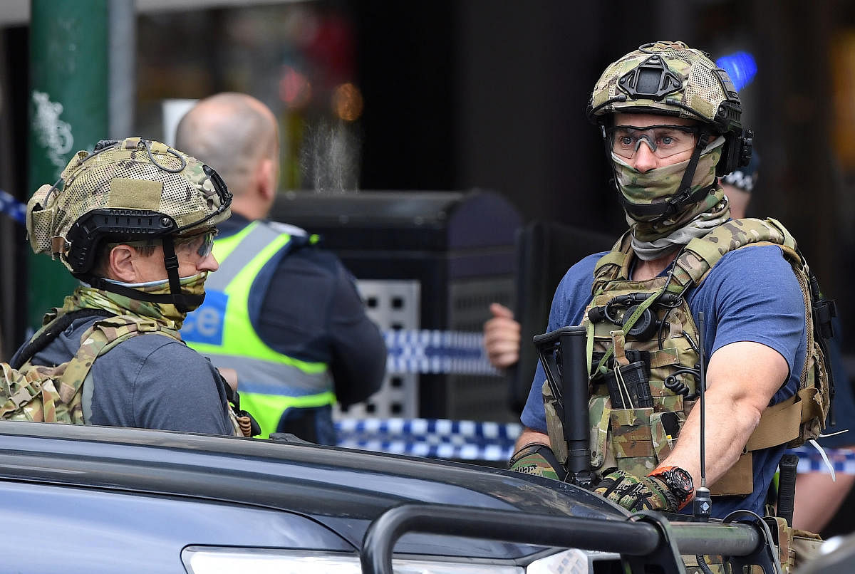 Armed security personnel stand near the Bourke Street mall in central Melbourne. Reuters Photo
