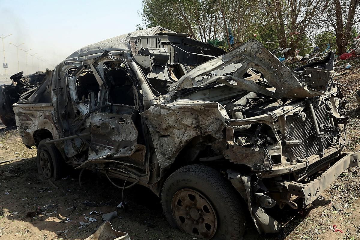 The wreckage of a car reportedly destroyed in an air strike in the downtown area of Hodeida. (AFP Photo)