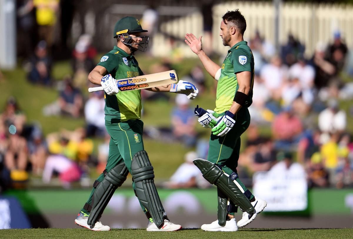 South Africa's David Miller (left) celebrates with team-mate Faf du Plessis after scoring a century against Australia in the third ODI on Sunday. AFP