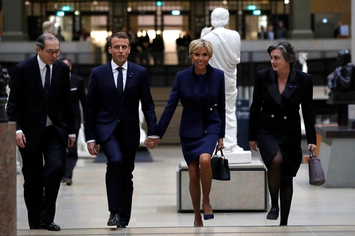 French president Emmanuel Macron and his wife Brigitte Macron arrive at the Musee d'Orsay in Paris on November 10, 2018 to attend a state diner and a visit of the Picasso exhibition as part of ceremonies marking the 100th anniversary of the 11 November 1918 armistice, ending World War I. AFP