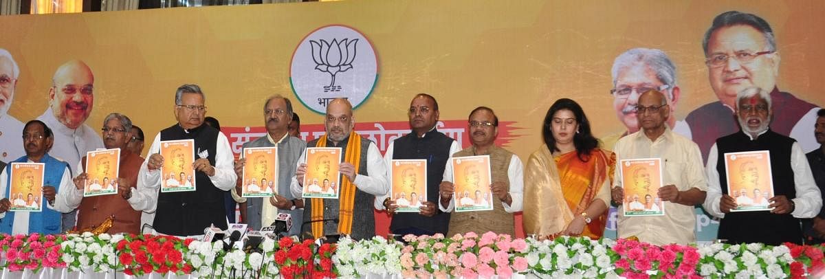 BJP president Amit Shah, Chhattisgarh Chief Minister Dr Raman Singh along with other leaders release their party's election manifesto for the poll-bound state.