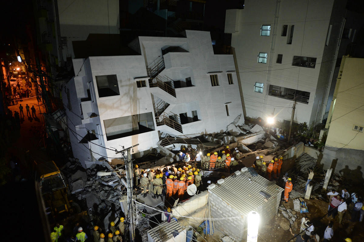 The building that tilted and collapsed on an adjacent structure in Thyagarajanagar on Saturday. DH PHOTOS/SATISH BADIGER
