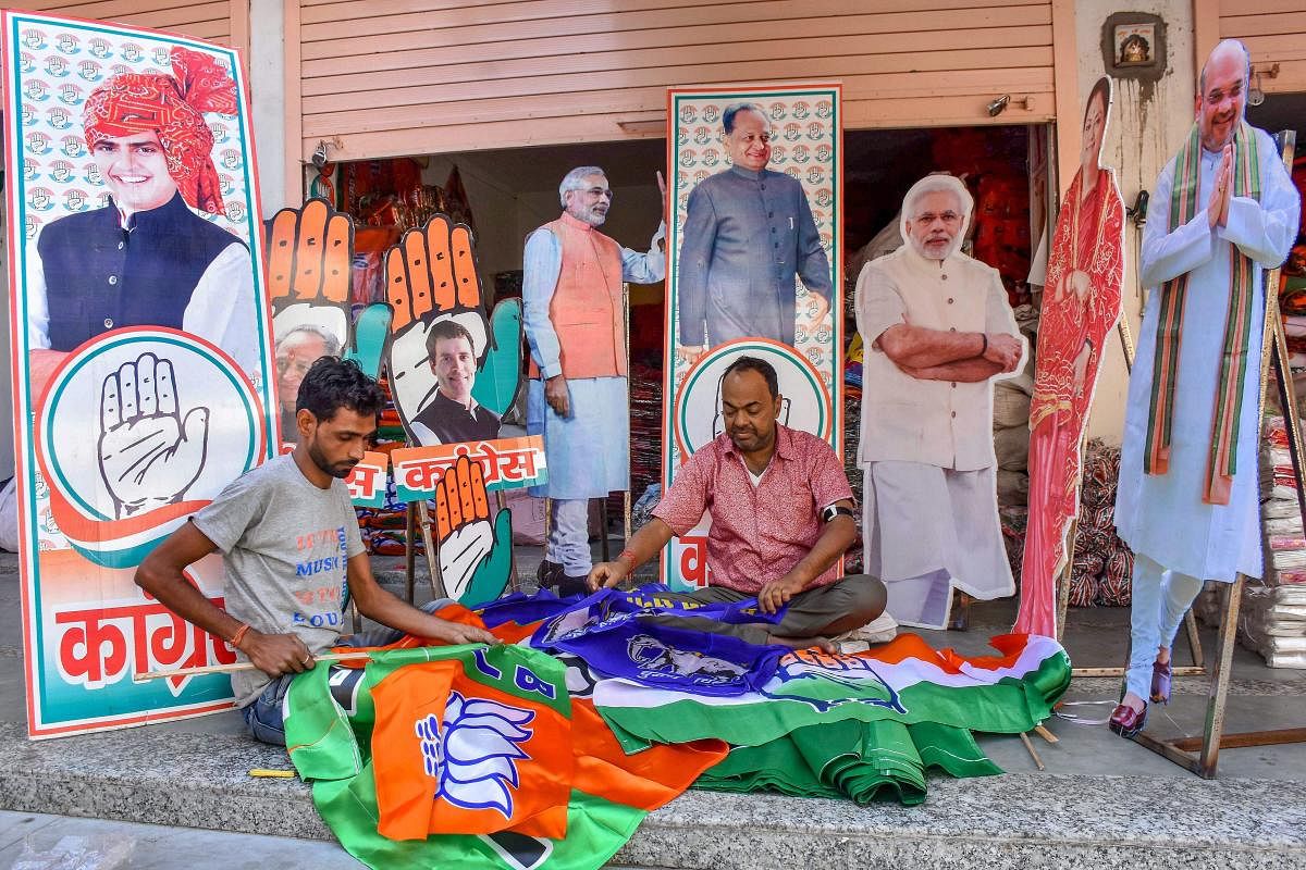 Workers prepare promotional materials for BJP and Congress ahead of the Rajasthan Assembly Elections, at Tripolia Bazaar in Jaipur, Wednesday, Nov 14, 2018. (PTI Photo)