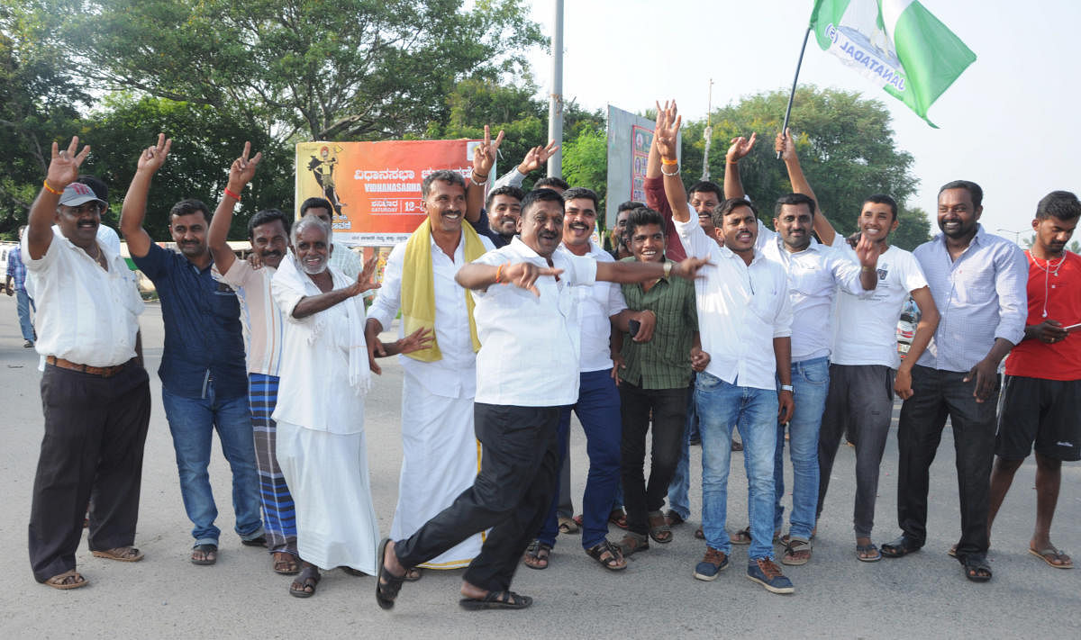 JD(S) party workers celebrate in K R Pet in Mandya district on Saturday.