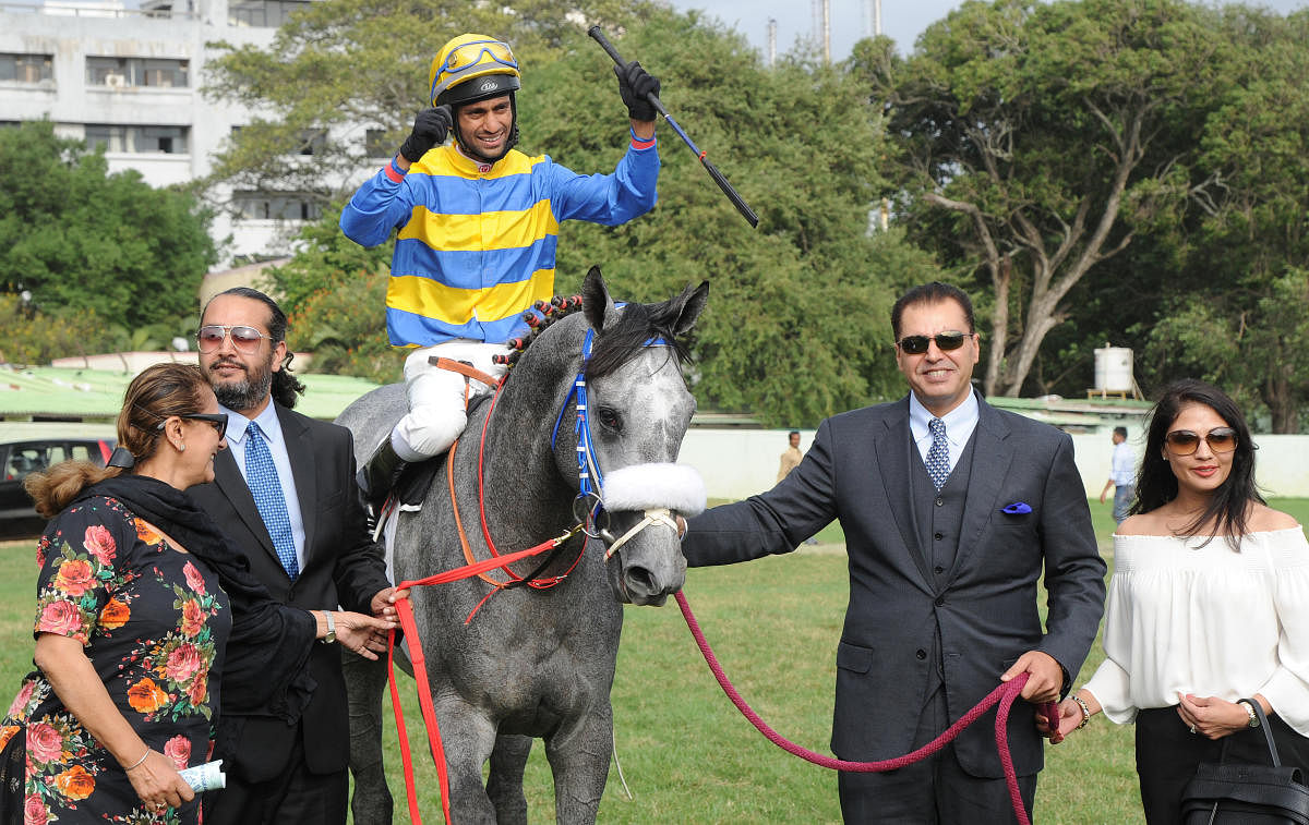 Sir Cecil (P Trevor astride) is led in by owners (from left) Harsimran, Karan Brar and Tegbir Brar after the colt clinched the Kingfisher Ultra Derby at the Bangalore Turf Club on Sunday. (DH PHOTOS/ SRIKANTA SHARMA R)