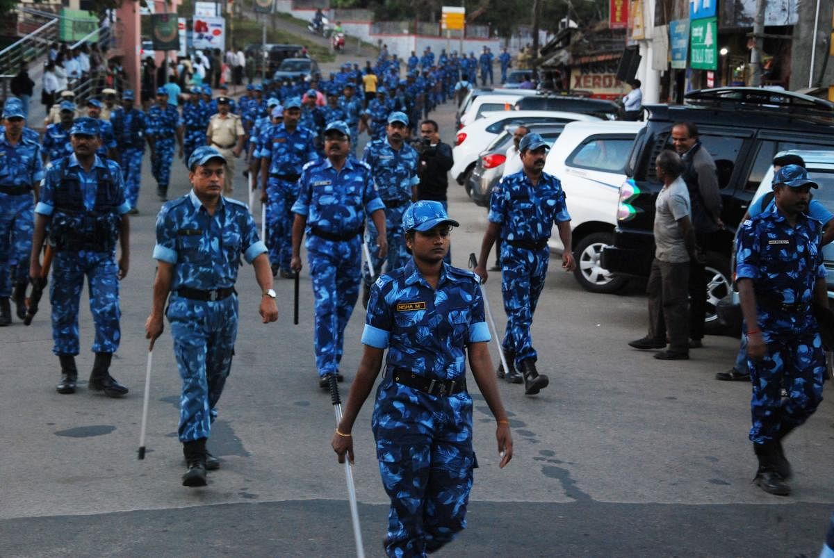 Rapid Action Force personnel take part in a route march organised to instil confidence among citizens, on the eve of Tipu Jayanti in Madikeri on Thursday. DH photo