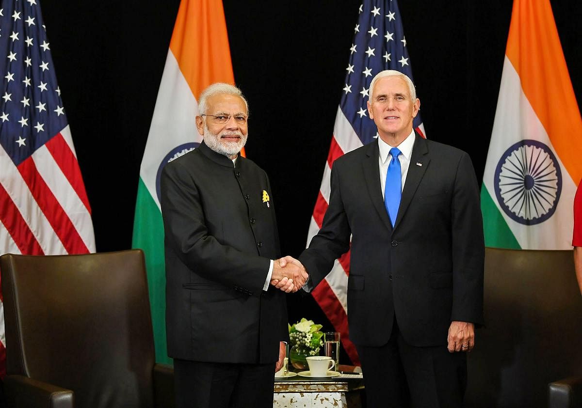Prime Minister Narendra Modi shakes hand with the US Vice President Michael Richard Pence, on the sidelines of East Asia Summit, in Singapore on November 14, 2018. PTI