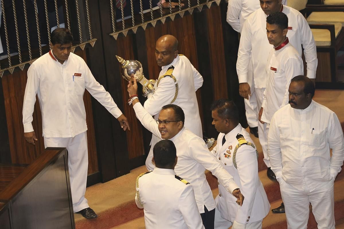 Udaya Padmashantha, member of the United Peoples Freedom Alliance (UPFA) that supports Prime Minister Mahinda Rajapaksa, is stopped from grabbing a mace after a no-confidence vote in Colombo, Sri Lanka. AP/PTI photo 