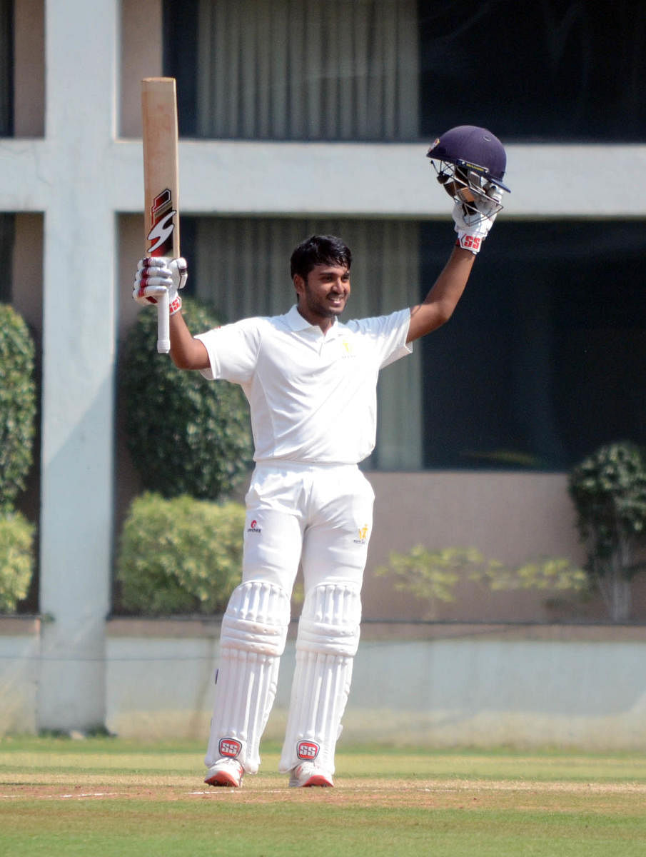 Karnataka’s B R Sharath celebrates after completing his ton on his debut on the third day of their Ranji Trophy match against Vidarbha in Nagpur on Wednesday. 