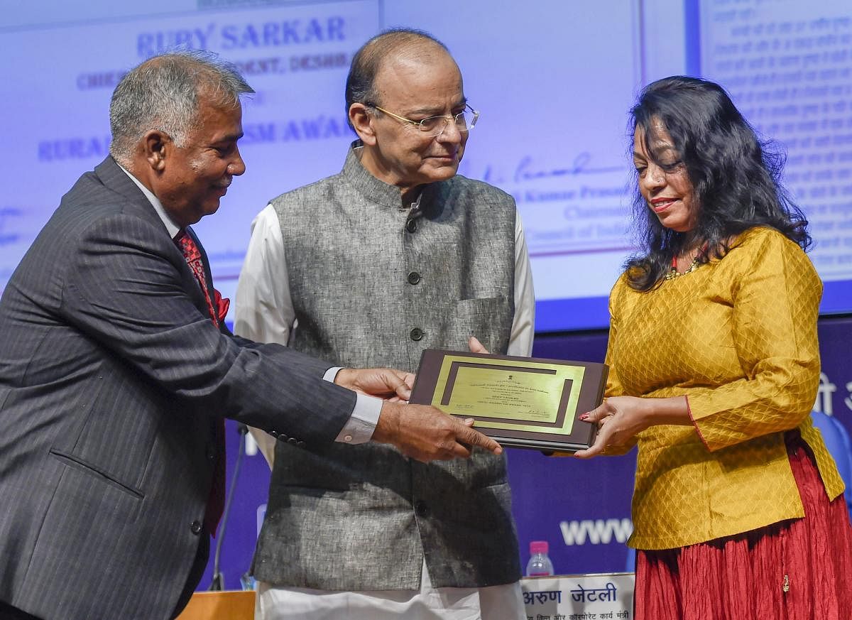 Finance Minister Arun Jaitley and Press Council of India Chairperson Justice Chandramauli Kumar Prasad present the 'Rural Journalism Award' to Chief Correspondent, Deshbandhu, Ruby Sarkar, during the National Press Day celebrations in New Delhi on Friday.