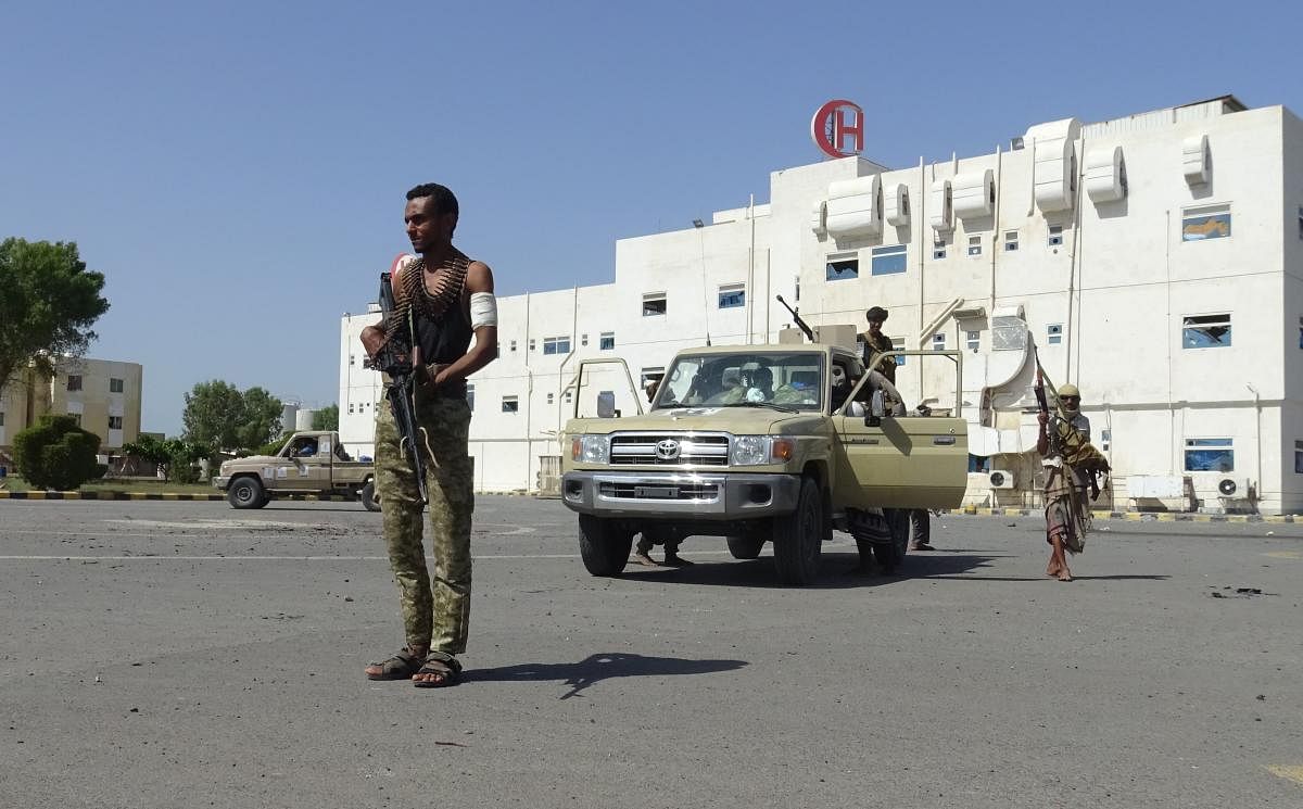 Members of the Yemeni pro-government forces gather in front of the May 22 Hospital on the eastern outskirts of port city of Hodeida. AFP