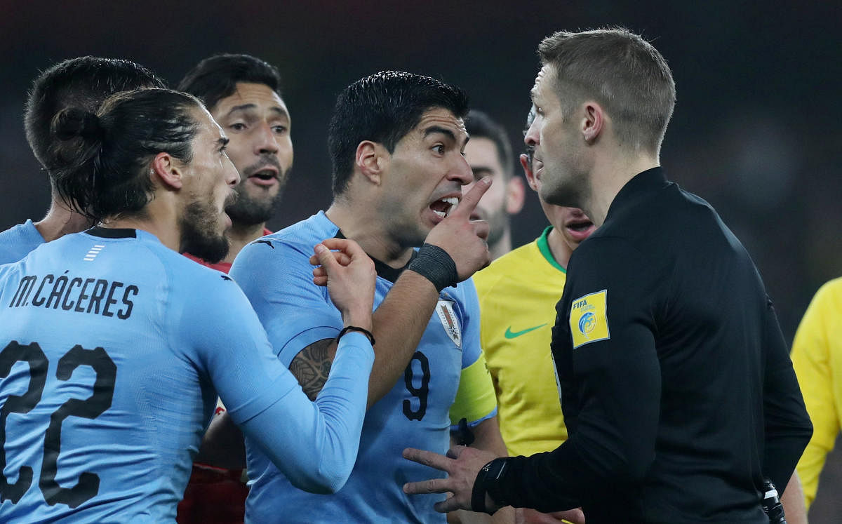 Uruguay's Luis Suarez argues with referee Craig Pawson after he awarded a penalty to Brazil. While the referee adjudged Danilo to have been brought down by Diego Laxalt, Uruguay claimed there was a handball from the Brazilian in the build-up