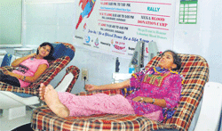 Two teenagers donate blood in Varanasi.