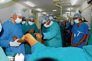 A surgery being performed on a polio-afflicted person in a NSS centre.