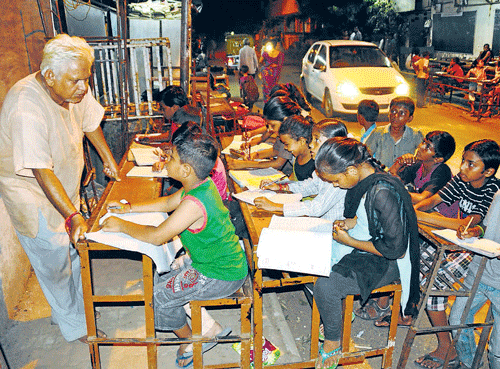 Kamlesh Parmar with his students on a footpath in Ahmedabad.
