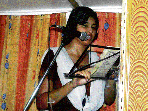 A girl in a studio recording textbooks for visually challenged students.