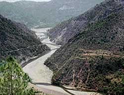 A panoramic view of the Giri river and surrounding mountains. The Renuka dam is proposed near the bridge (circled) seen in the picture.