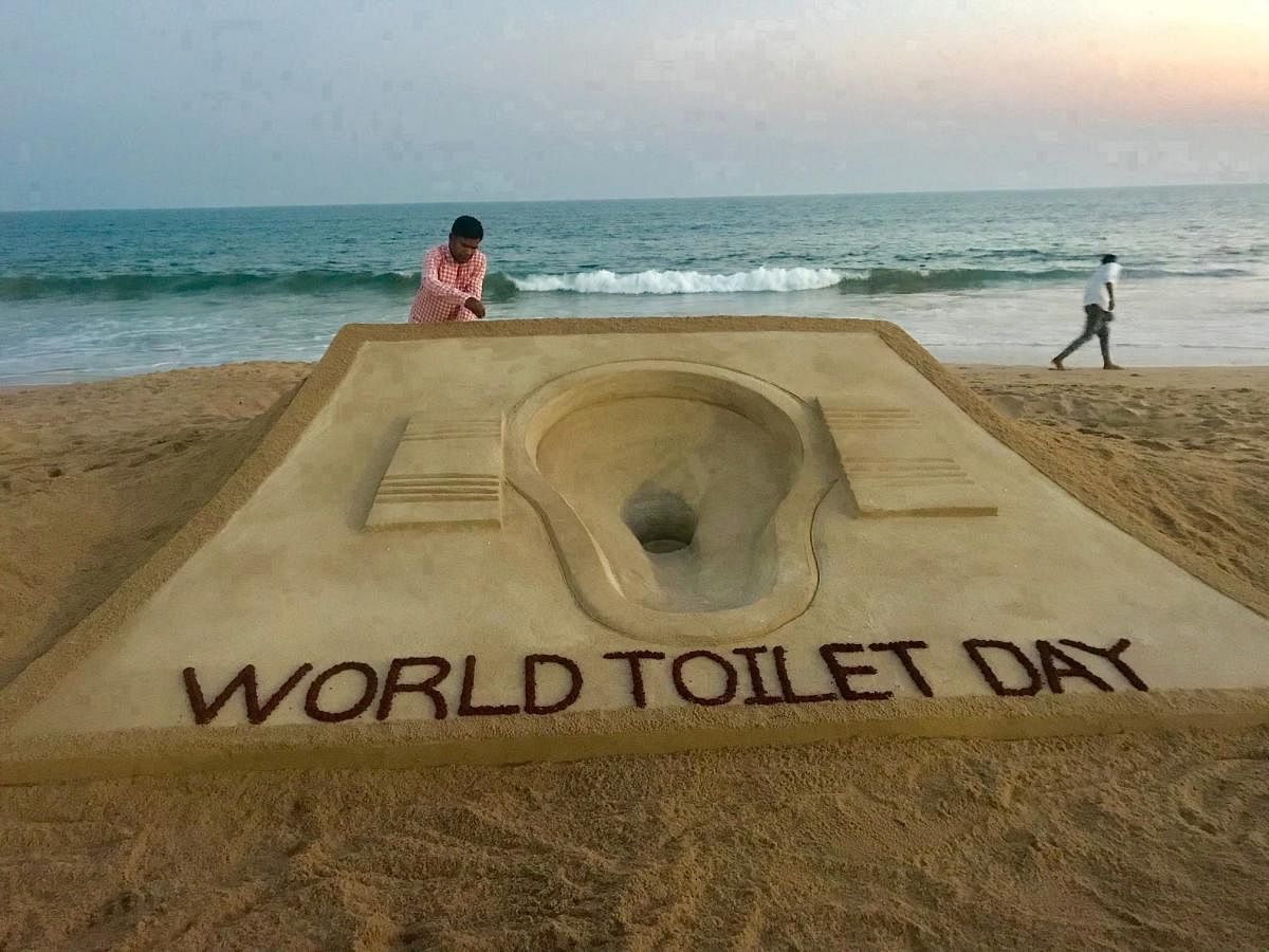 Sand artist Sudarsan Pattnaik creates a sand sculpture on the eve of 'World Toilet Day' at Puri beach of Odisha. The toilet crisis is most severe in parts of Africa and Asia facing extreme poverty and seeing a population boom. (PTI Photo)