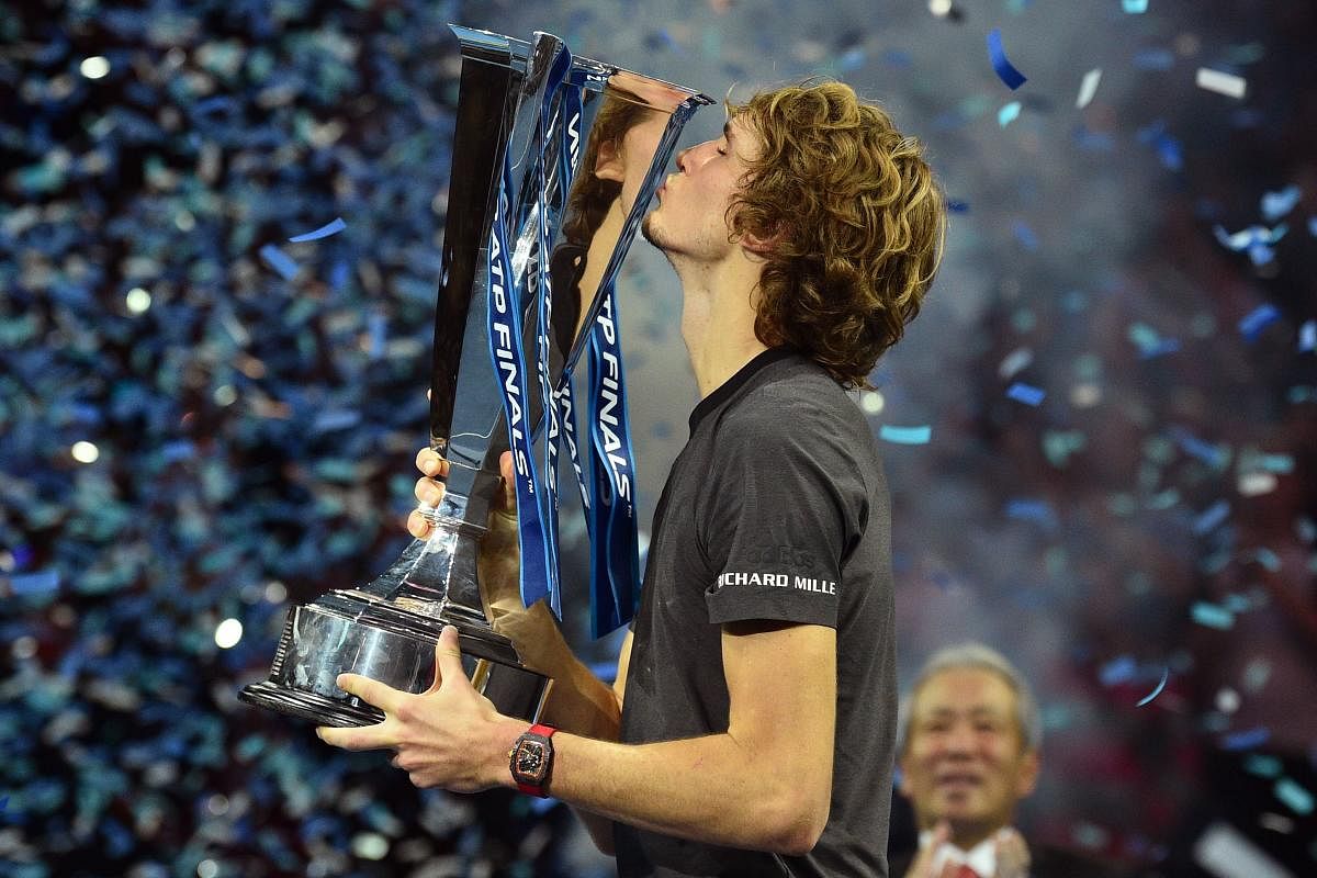 TASTE OF VICTORY: Germany's Alexander Zverev kisses the trophy after beating Serbia's Novak Djokovic in the title clash of the ATP World Tour Finals in London on Sunday. AFP