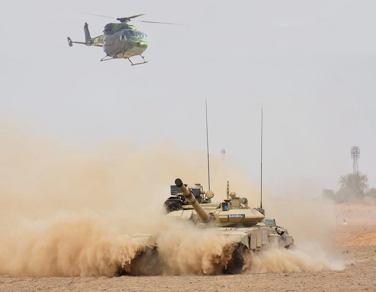 A helicopter and a tank in coordinated action during the practice of 'Air Cavalry' concept in recently concluded exercise 'Vijay Prahar' at Mahajan Field Firing Range in Rajasthan. PTI file photo