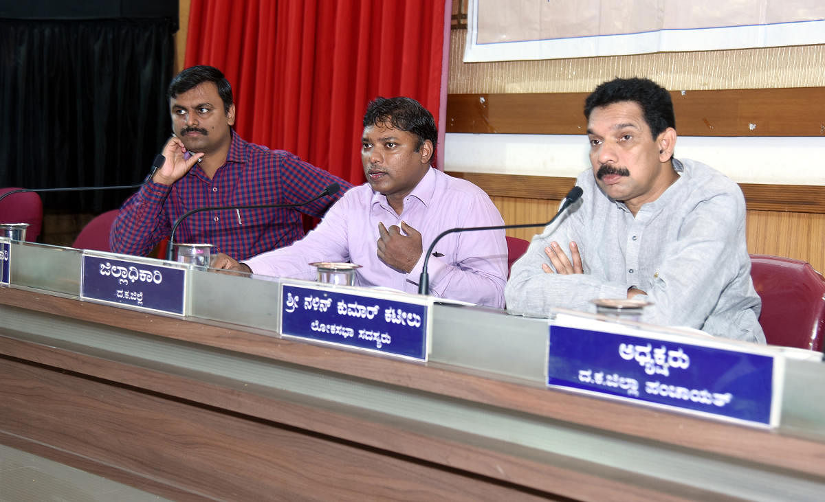 Deputy Commissioner Sasikanth Senthil (centre) speaks at the Development Coordination and Monitoring Committee meeting in Mangaluru recently.
