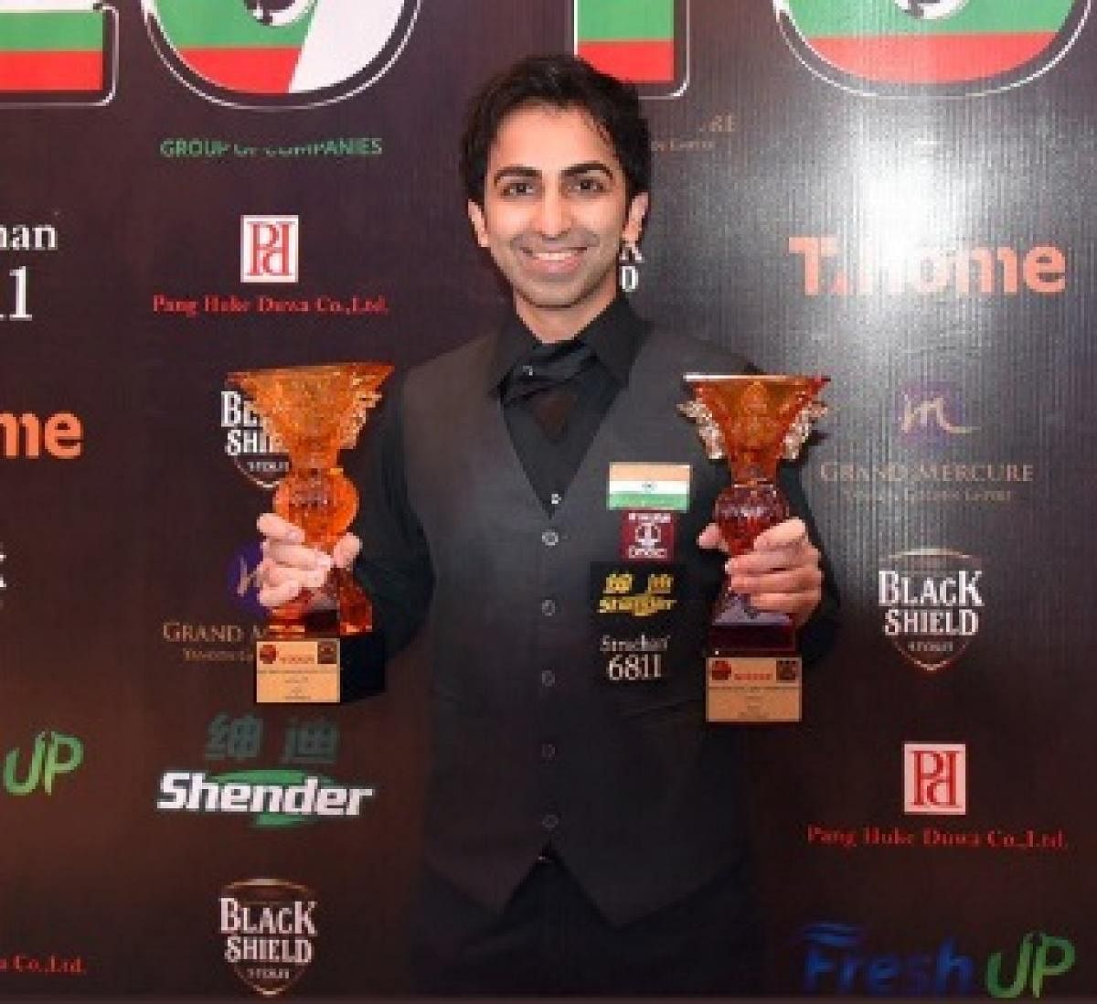 Pankaj Advani poses with the long and points format titles which he won in the ongoing IBSF World Billiards Championship. TWITTER 