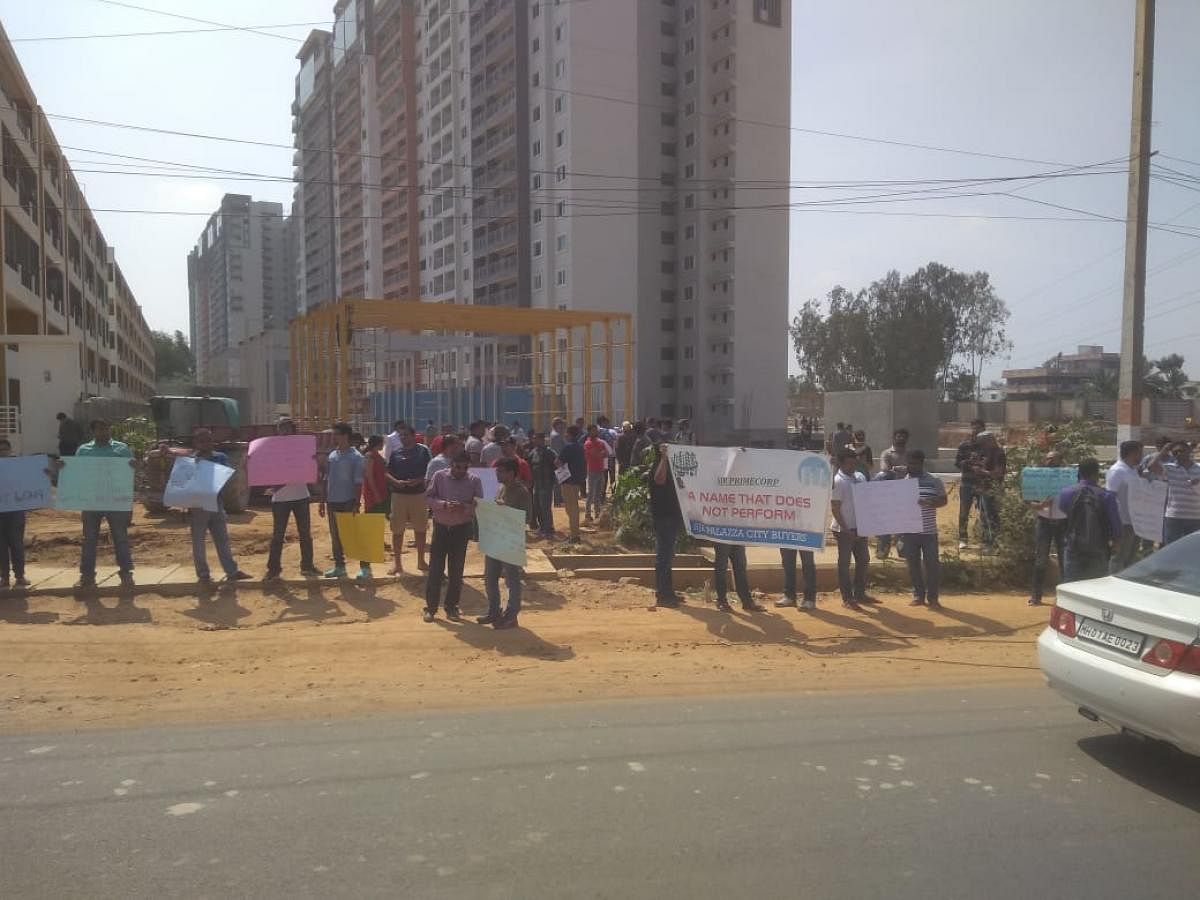 More than 75 buyers protest against the builder for delay in handing over the flats.