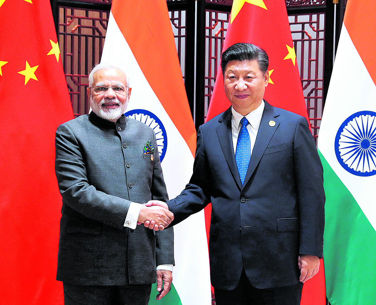 Xiamen : In this photo released by China's Xinhua News Agency, Indian Prime Minister Narendra Modi, left, and China's President Xi Jinping shake hands as they pose for a photo during a meeting on the sidelines of the BRICS Summit in Xiamen in southeastern
