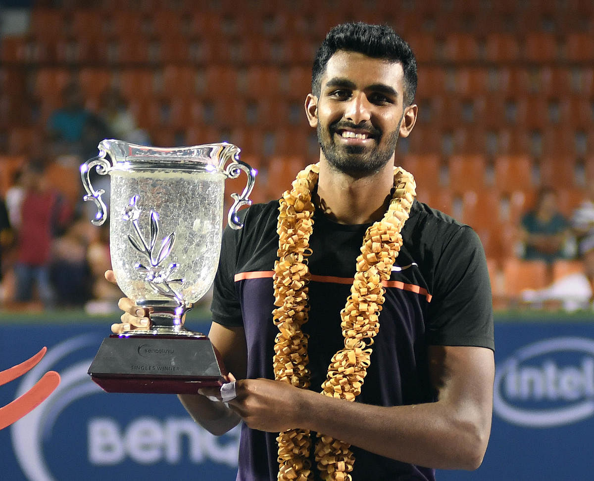 Prajnesh Gunneswaran with the Bengaluru Open trophy after defeating Saketh Myneni in Bengaluru on Saturday. Prajnesh won 6-2, 6-2. DH Photo/ Srikanta Sharma R