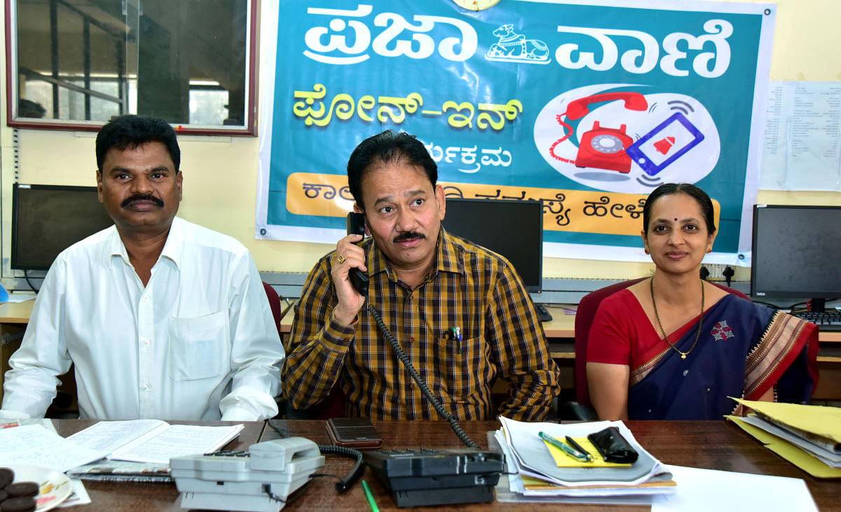 Fisheries department Joint Director Ramacharya receives a call during a phone in programme organised by DH-PV, at DH-PV editorial office in Balmatta, Mangaluru on Tuesday. Deputy Director Chikkaveera Nayak and Assistant Director Sushmitha look on.