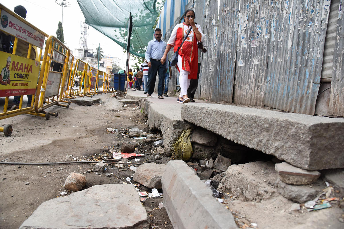 A pedestrian path in bad condition at the entrance of Mantri Square Sampige Metro Station. DH Photo/ B H Shivakumar