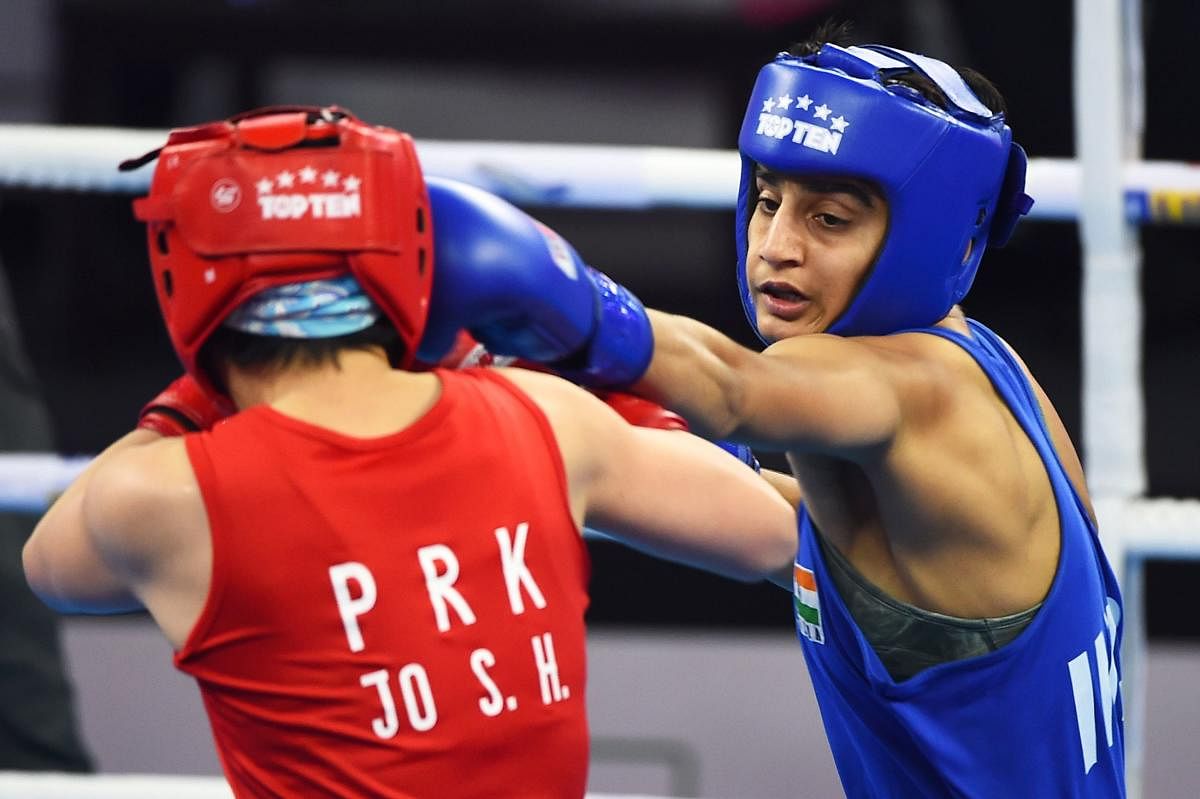 FIGHTER India’s Sonia (right) lands a punch on Son Hwa Jo of North Korea in the 57 kg category semifinal of the Women’s World Boxing Championships in New Delhi on Friday. AFP