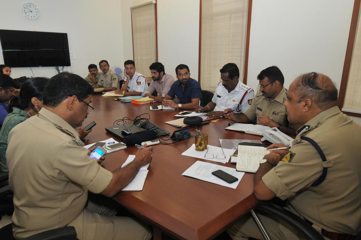 Mangaluru City Police Commissioner T R Suresh attends phone calls during the phone-in programme on Friday.