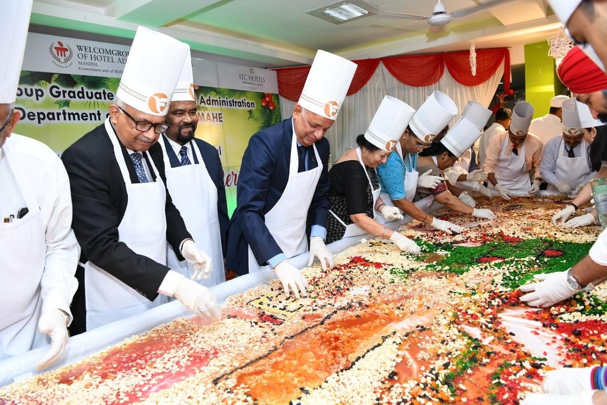 Vasanti R Pai, Trustee MAHE and wife of Chancellor Dr Ramdas M Pai, Dr H S Ballal, Pro Chancellor, Dr H Vinod Bhat, Vice Chancellor and other officials at fruit mixing ceremony for Christmas cake, held at Culinary Arts Hostel Mess, WGSHA.