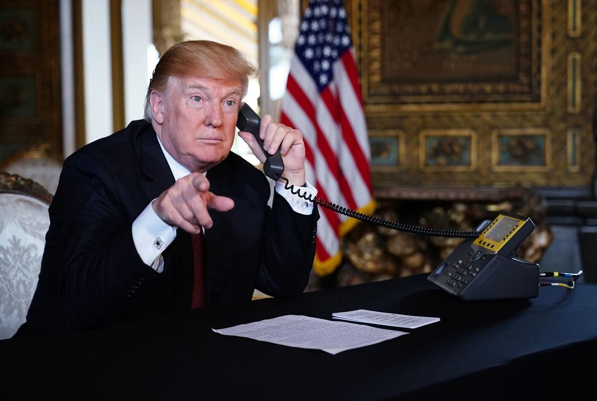 US President Donald Trump speaks to members of the military via teleconference from his Mar-a-Lago resort in Palm Beach, Florida, on Thanksgiving Day, on November 22, 2018. AFP