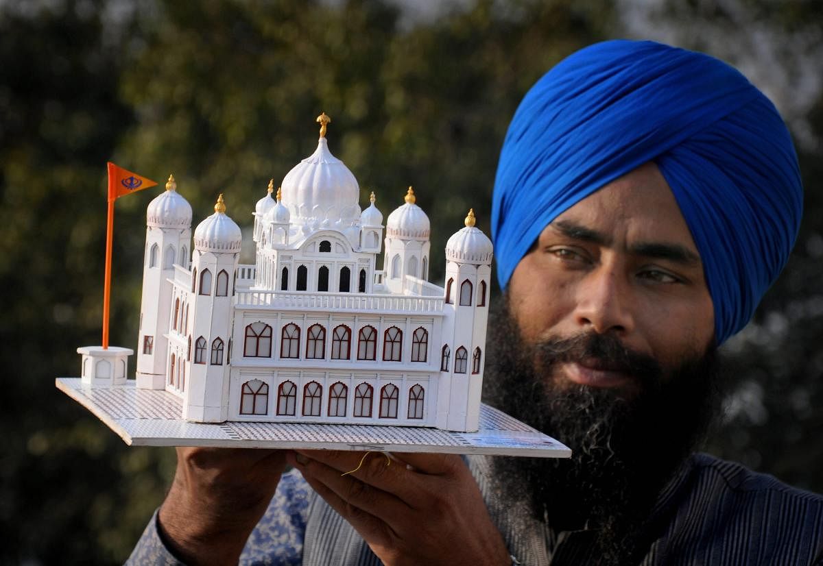 Amritsar: Paper artist Gurpreet Singh shows his creation, a paper model of Guru Nanak Dev Ji's gurudwara (Kartarpur Sahib) in Pakistan, in Amritsar, Thursday, Nov. 22, 2018. The Indian government has given permissions to build a corridor on the Indian side which would felicitate pilgrims to go across the border to pay obeisance at the sacred Sikh shrine. (PTI Photo)