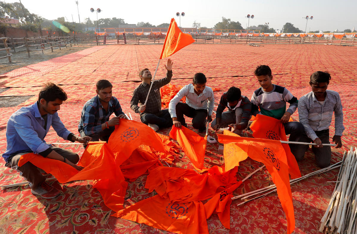 VHP supporters prepare flags at the venue of Sunday's "Dharam Sabha" or a religious congregation in Ayodhya, Uttar Pradesh, on Saturday. REUTERS