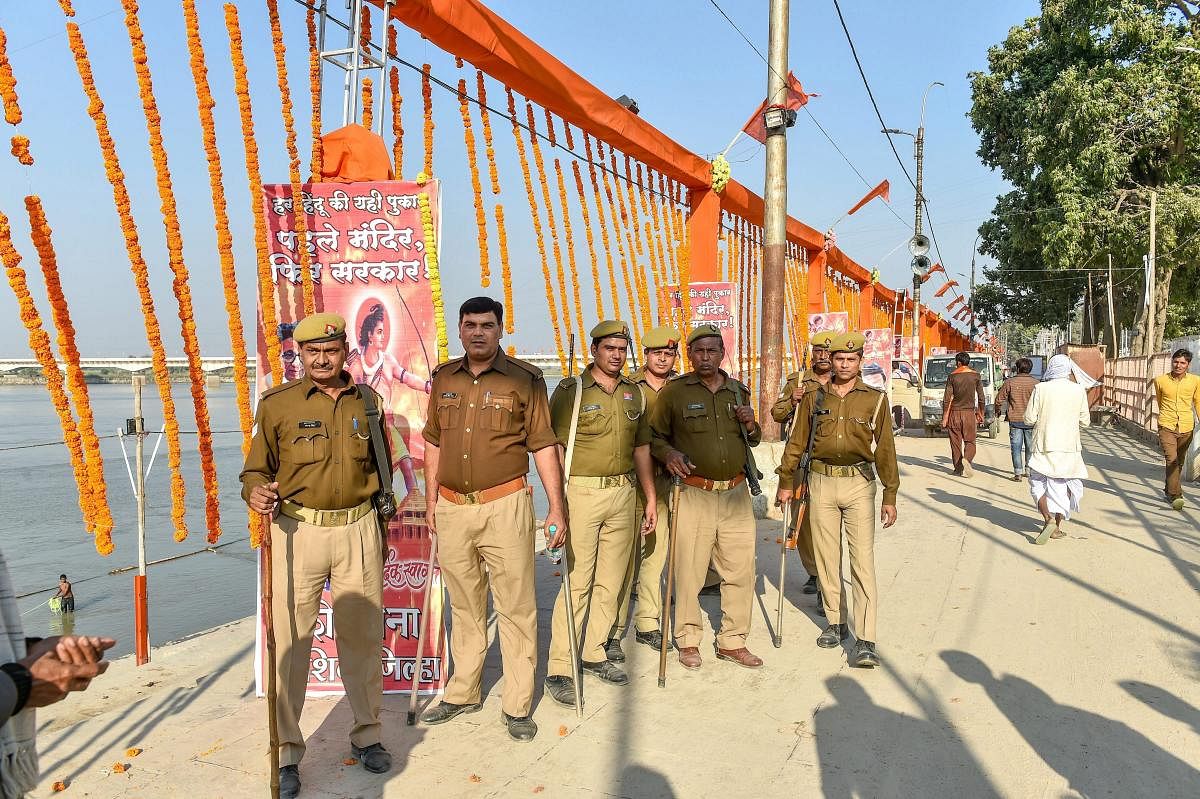 Security personnel stand guard at Lakshman Kila ahead of the Ram Temple event separately organised by Shiv Sena and the Vishva Hindu Parishad (VHP) to be held tomorrow, in Ayodhya, Saturday. (PTI Photo/Nand Kumar)