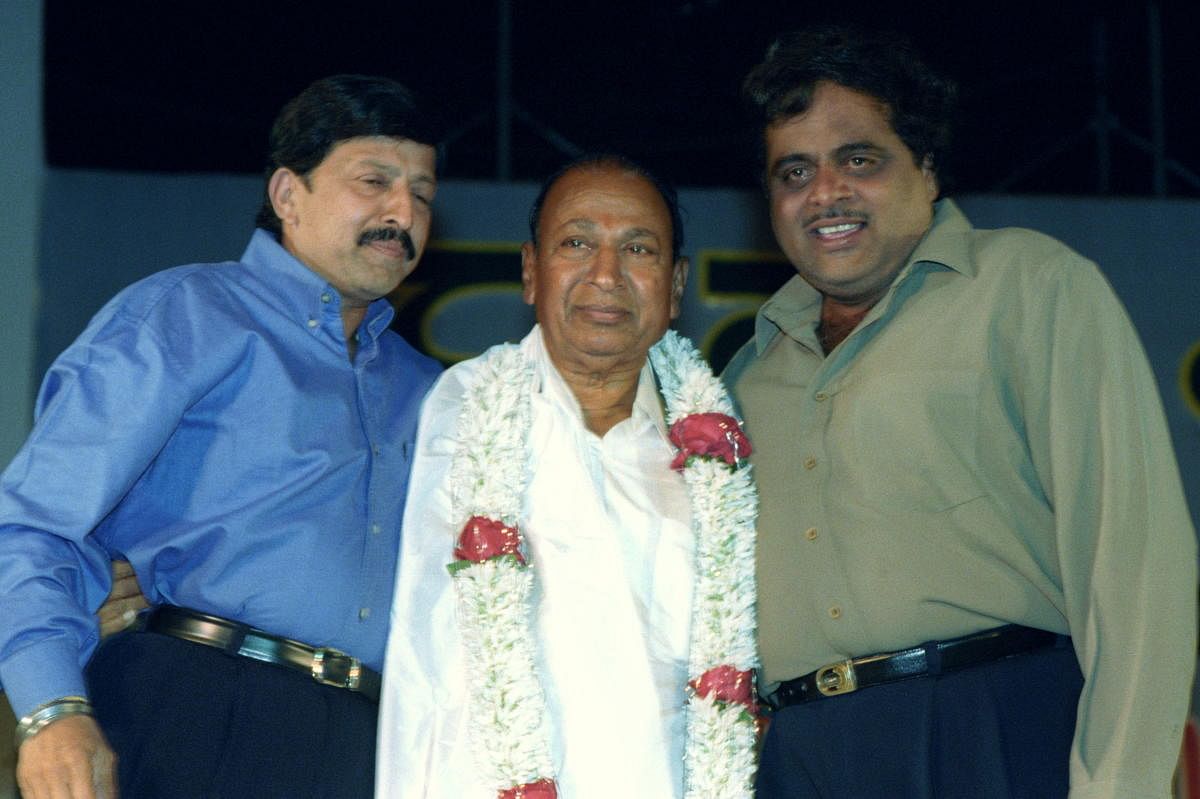 BIG THREE: Close friends Ambareesh and Vishnuvardhan greet Kannada thespian Rajkumar at an event in December 2000. DH File Photo
