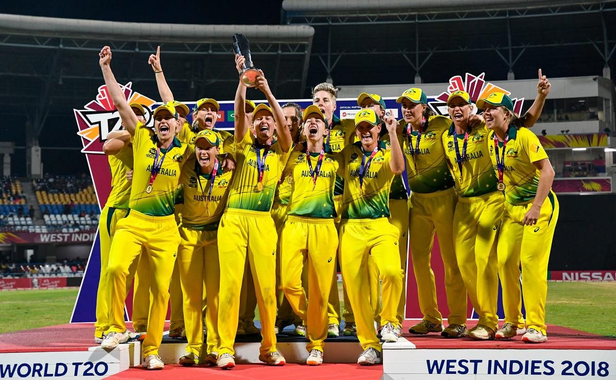 Australia's players celebrate winning the ICC Women's World T20 final cricket match against England at Sir Vivian Richards Cricket Ground, North Sound, Antigua and Barbuda, on November 24, 2018. (Photo by Randy Brooks / AFP)