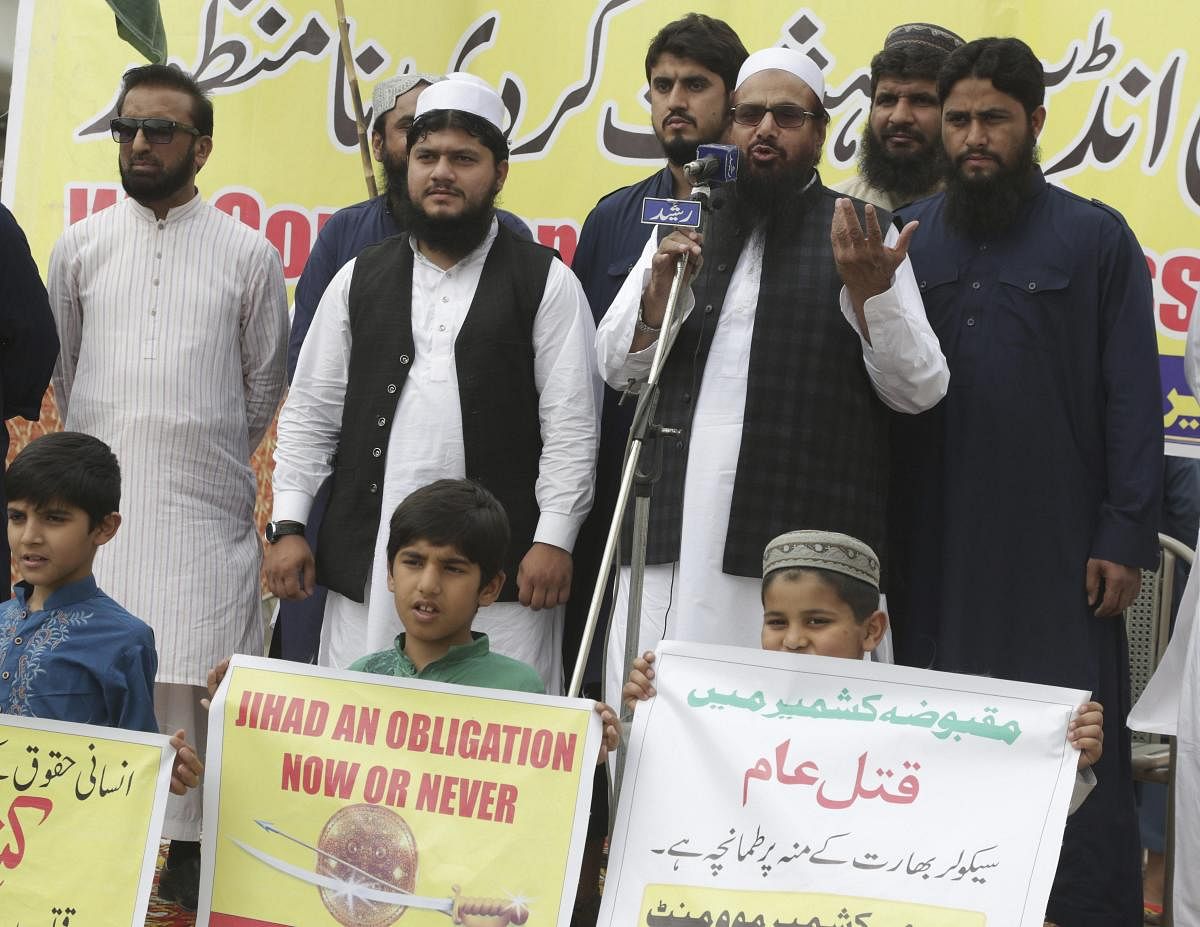 Hafiz Saeed, head of the Pakistani religious party, Jamaat-ud-Dawa addresses a rally to express solidarity with Indian Kashmiris in Lahore, Pakistan, Friday, April 13, 2018. They have rallied to denounce the recent killings by Indian forces in the dispute