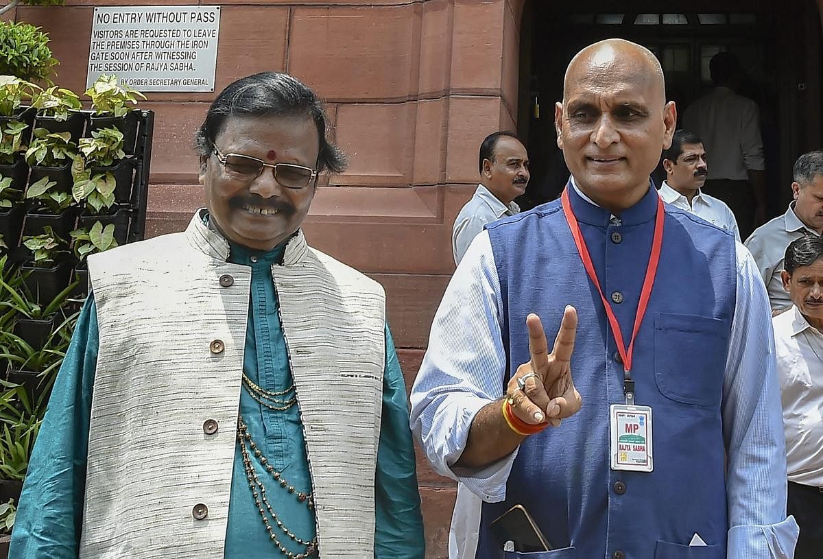 New Delhi: Newly sworn-in Rajya Sabha members Raghunath Mohapatra and Rakesh Sinha pose for a photograph, on the first day of the Monsoon Session of Parliament, in New Delhi on Wednesday, July 18, 2018. (PTI Photo /Kamal Singh)(PTI7_18_2018_000093B)