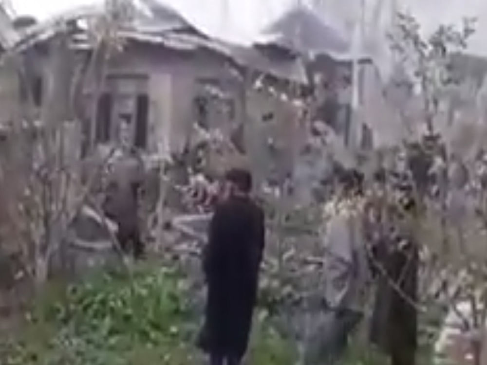 The 1: 26-minute amateur video shows how civilians help a militant escape from the rubble of a house which was badly damaged by explosives.  
