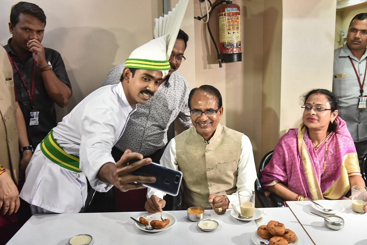 Madhya Pradesh Chief Minister Shivraj Singh Chouhan with his wife Sadhna Singh pose for a selfie at Indian Coffee House, in Bhopal. PTI Photo 
