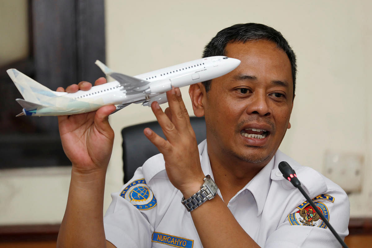 Indonesia’s National Transportation Safety Committee sub-committee head for air accidents, Nurcahyo Utomo, holds a model airplane while speaking during a news conference on its investigation into a Lion Air plane crash last month, in Jakarta, Indonesia