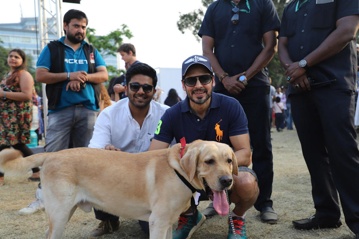 Akshay Gupta, founder of PetFed and actor Dino Morea pose for a picture with a dog at Mumbai Pet Fed 2017.