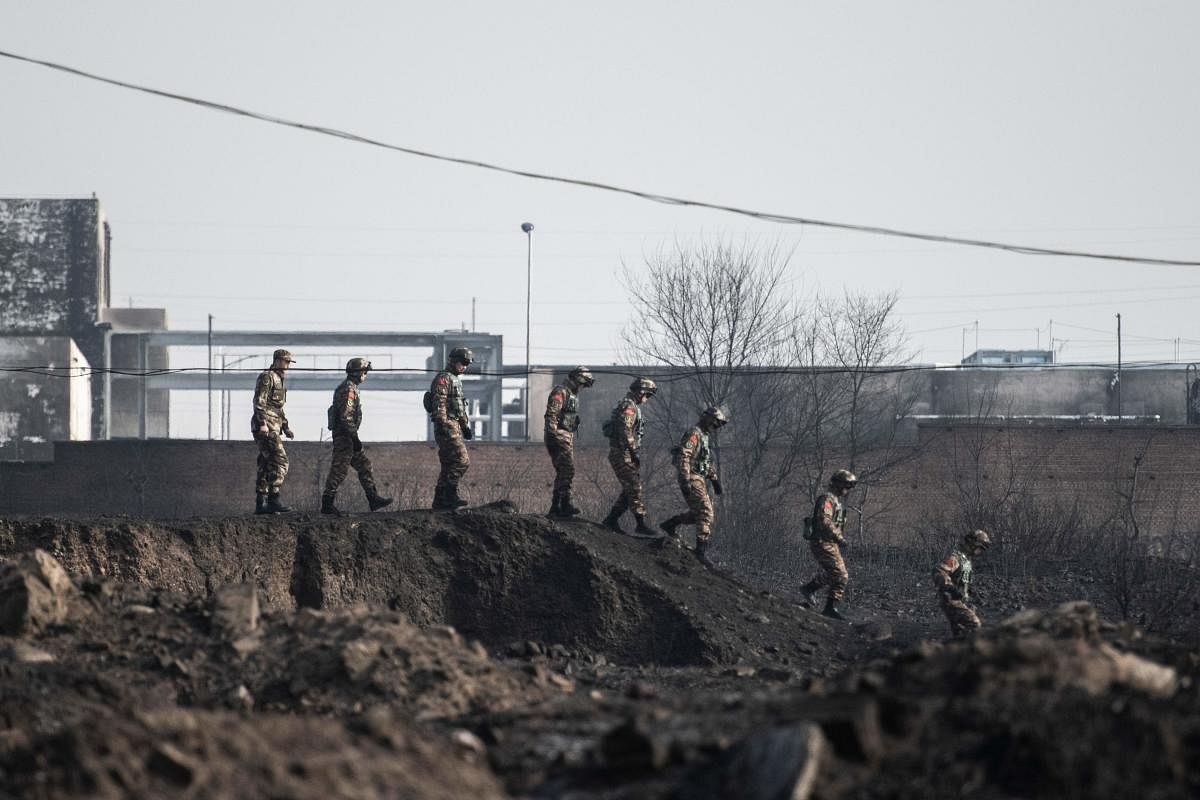 Members of the Chinese military inspect the area after an explosion near a chemical factory in Zhangjiakou, some 200km northwest of Beijing on November 28, 2018. AFP