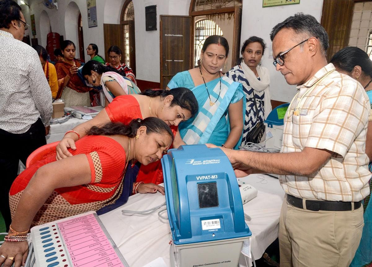 Electoral officials demonstrate the functioning of an Electronic Voting Machine and Voter-Verified Paper Audit Trail during a voter awareness program ahead of Madhya Pradesh State Assembly elections, in Jabalpur on Friday. PTI
