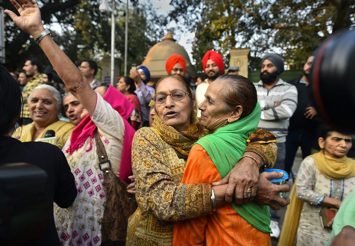 Family members of the victims of 1984 anti-Sikh riots celebrate outside the Patiala House Court in New Delhi, Tuesday, Nov 20, 2018, after the pronouncement of the first death punishment in the case. (PTI Photo/Kamal Singh)