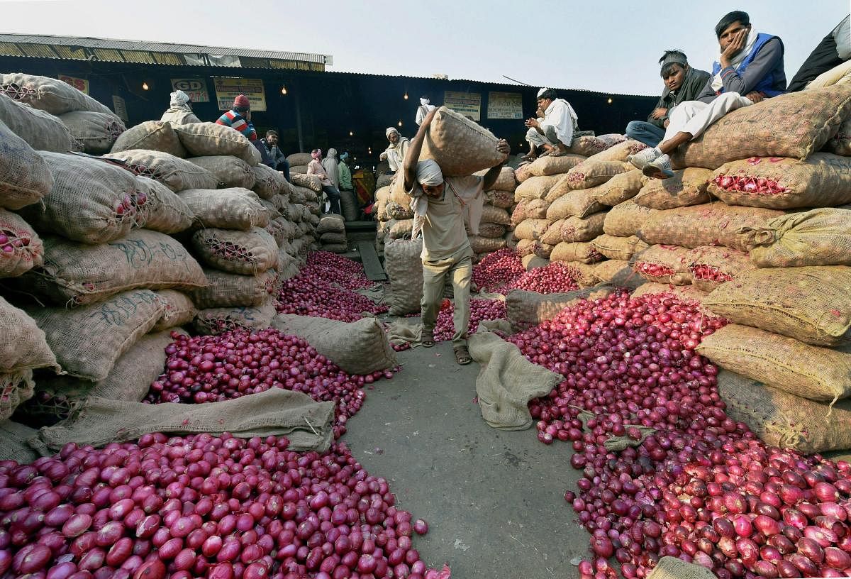 New Delhi: Heap of onion sacks at Azadpur Sabzi Mandi in New Delhi on Monday as the prices of the vegetable continue to soar. PTI Photo by Shahbaz Khan(PTI11_27_2017_000079B)
